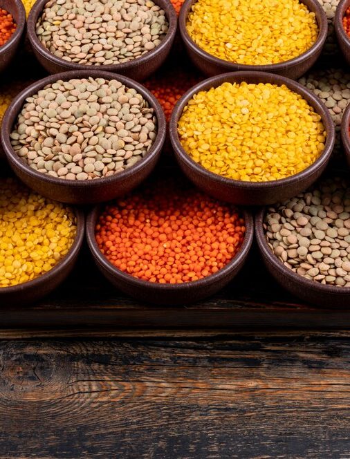 some-yellow-green-red-lentils-brown-bowls-dark-wooden-table-high-angle-view_176474-2178