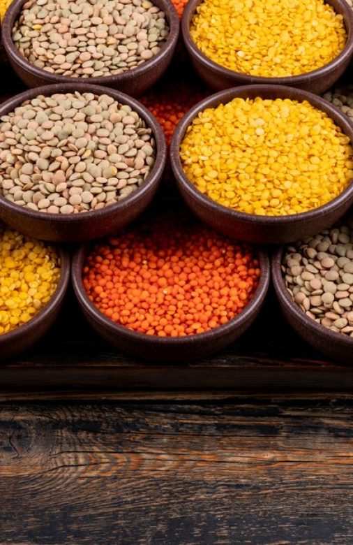 some-yellow-green-red-lentils-brown-bowls-dark-wooden-table-high-angle-view_176474-2178