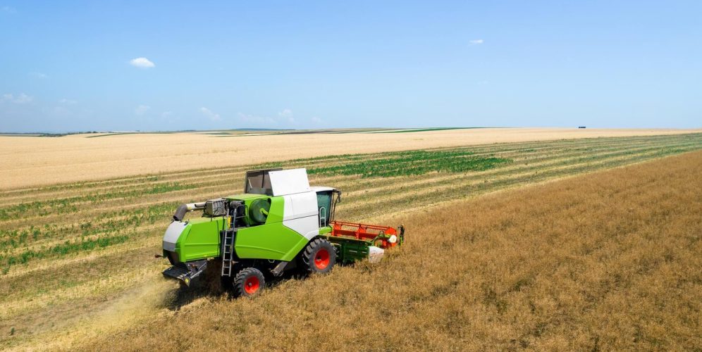 aerial-drone-view-harvester-gathering-crops_1268-20599