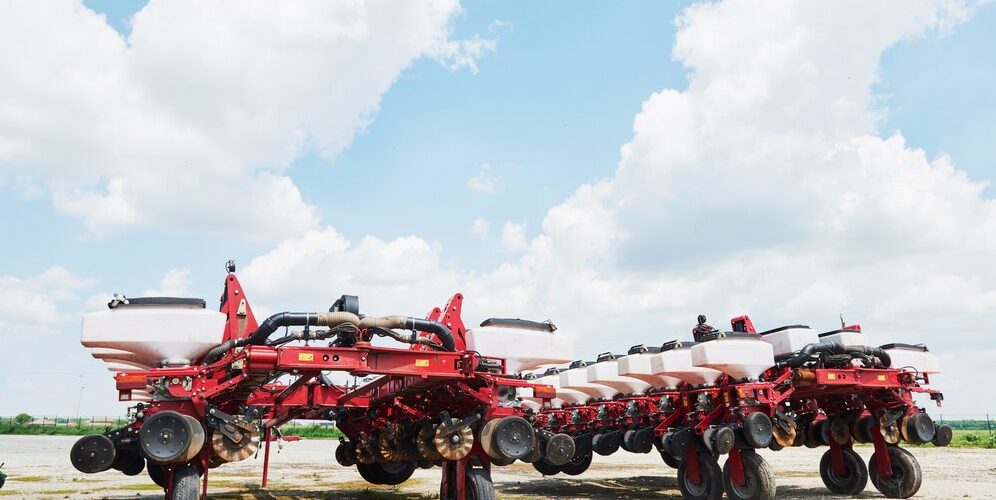 close-up-seeder-attached-tractor-field_146671-19083
